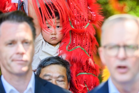 Lion dancers are seen in the background as prime minister Anthony Albanese speaks to the media during lunar new year celebrations in Sydney.