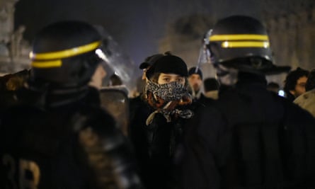 Protesters confront riot police in Paris.