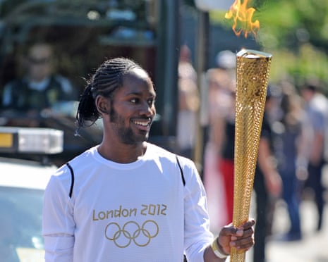 Jason Arday carries the Olympic Flame on the Torch Relay leg between Sutton and Merton in 2012.