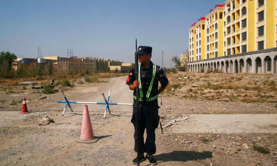 A Chinese police officer near a “re-education camp” in Xinjiang.