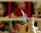 A gloved hand holds a syringe