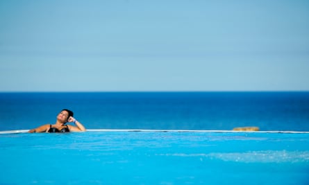 Woman in infinity pool in sunshine, Alpamare
