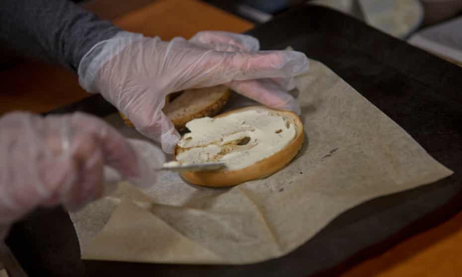 A bagel receives its traditional accompaniment of cream cheese at a New York business.