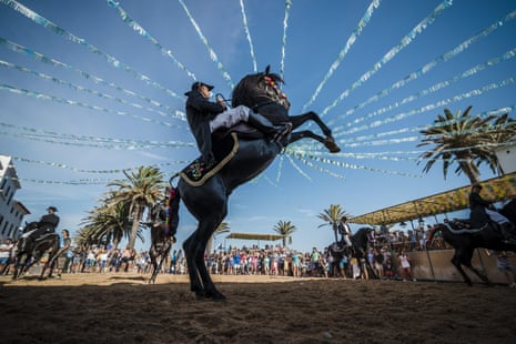 A caixer (horse rider) rears up on his horse during the traditional Sant Antoni festival in Fornells, Menorca.