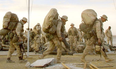 US Marines from India company march with their gear as they prepare to depart the American military compound at Kandahar Airport, Afghanistan.