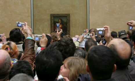 Crowds view the Mona Lisa at the Louvre, Paris.