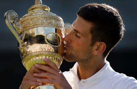 Novak Djokovic kisses the trophy after winning Wimbledon in 2022