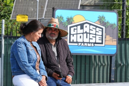 two people standing by a sign