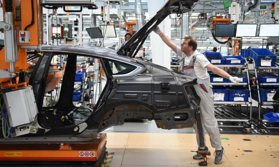 Workers assemble Audi sedans on an assembly line at the Ingolstadt plant
