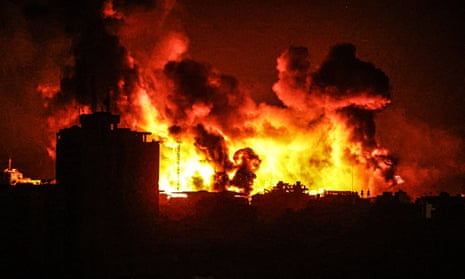 Smoke and flames rise above Gaza City on Sunday night as a result of Israeli attacks.