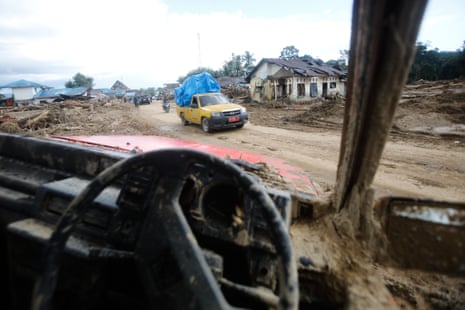 A view through the wreckage of a car at a village affected by a flash flood in Batang Toru in North Sumatra, Indonesia.