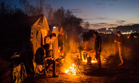 Migrants outside their tents in the Bosnian town of Velika Kladusa, close to the border with Croatia