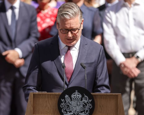 Keir Starmer with his head down at the Downing Street lectern.