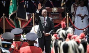 Uhuru Kenyatta waves to guards of honour after his arrival to take oath of office at Kasarani stadium in Nairobi.