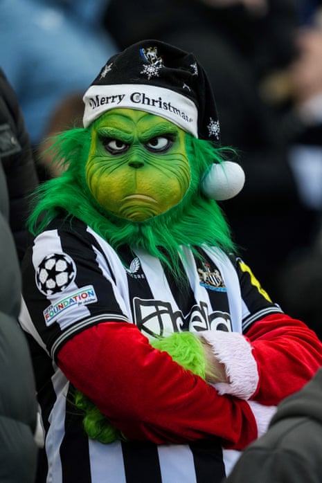 A Newcastle fan wears a Grinch mask to sum up the current mood at St |James' Park. 