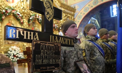 A graveside cross is pictured during the funeral service of Ukrainian defender, volunteer Denys Halushko, who was kileld while fighting Russian forces near Bakhmut in the Donetsk region.