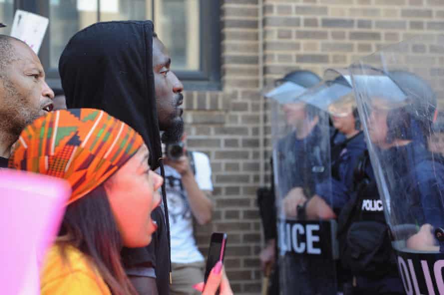 Bruce Franks, a former Missouri state representative, faces police in riot gear as protestors demonstrate in St Louis in 2017.