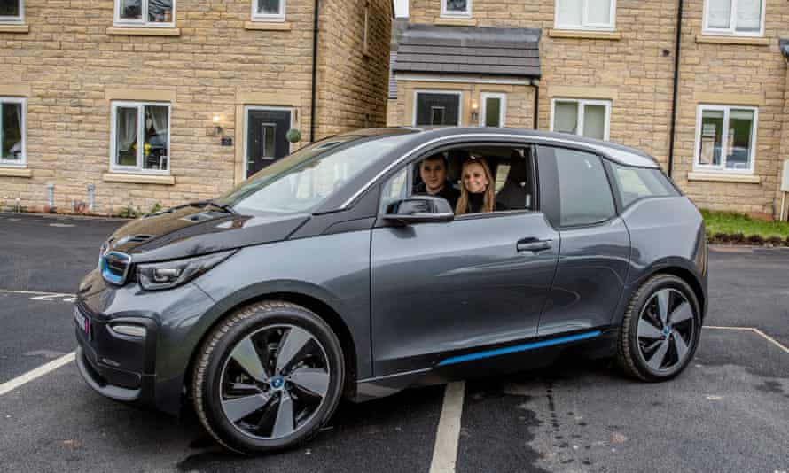 Nicolas Raimo and his partner in their EV.