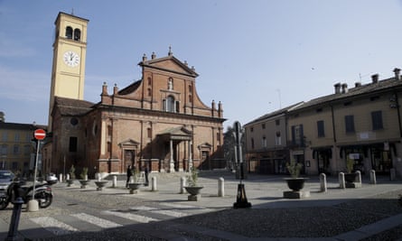 Two reporters stand in front of the San Biagio church in Codogno.