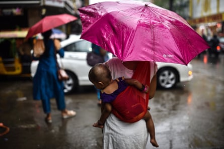 A woman carrying a baby on her back in Chennai, Tamil Nadu.
