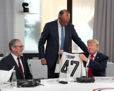US president Donald Trump holds up a German national team football shirt with the number 47.