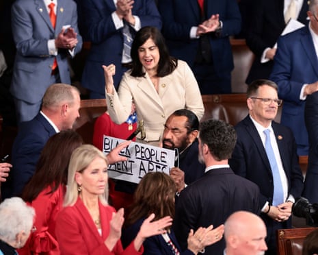 Al Green holds a sign as Donald Trump delivers the State of the Union address to a joint session of Congress, 24 February 2026.