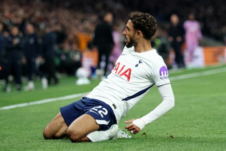 Omar Marmoush slides on his knees across the pitch, celebrating after scoring