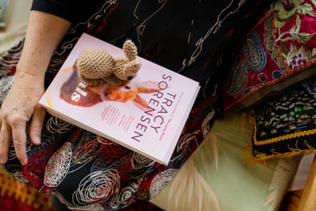 A closeup of Sorenson’s book The Vitals in her lap with a crocheted bunny on top