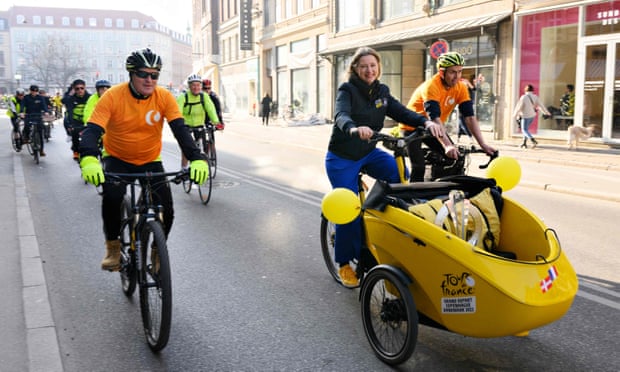 Copenhagen’s city mayor, Sophie Hæstorp Andersen, cycles on a cargo bike as she transports the Tour de France Grand Départ trophy to City Hall.