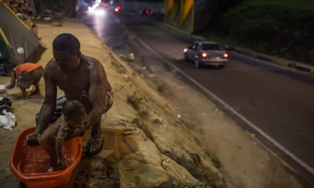 Man washes child in Brazil