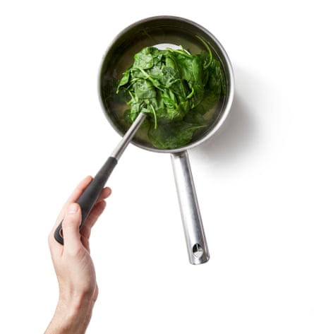 A pan of spinach. …While the rice is drying and cooking, blanch the spinach, if using fresh, in boiling water for a minute, then scoop out with a slotted spoon, rinse under cold water and squeeze out as much excess liquid as you can; if using defrosted spinach, simply squeeze it dry. Roughly chop the spinach, mix it with the crushed garlic, oil and soy sauce, then season to taste and sprinkle with sesame seeds, and set aside.