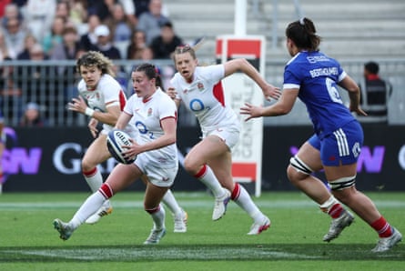 Lucy Packer runs with a rugby ball playing for England against France.