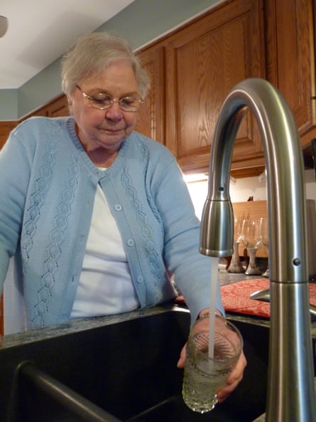 Councillor Julie Adams fills a glass of water from her kitchen tap.
