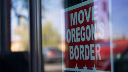 A red and white sign inside a window reads “Move Oregon’s border.”
