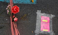 Vigil at a makeshift memorial outside the Gold Spa in Atlanta<br>A placard taped to the ground is pictured next to flowers during a vigil at a makeshift memorial outside the Gold Spa following the deadly shootings in Atlanta, Georgia, U.S. March 21, 2021. REUTERS/Shannon Stapleton