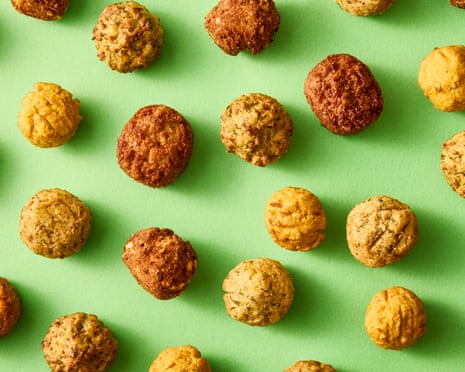 Falafel... little brown balls lined up on a pea-green background