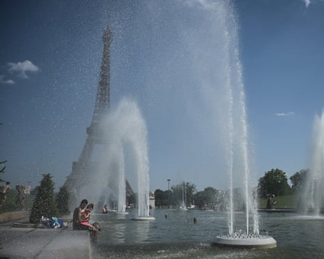 People jump in the Trocadero Fountain near the Eiffel Tower in Paris on Monday