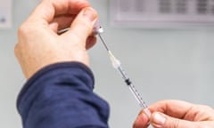 A pharmacist prepares a Covid-19 vaccination booster shot