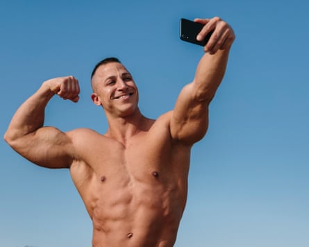 A bodybuilder taking a selfie.