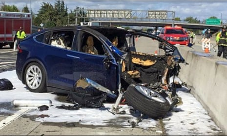 Emergency personnel work a the scene where a Tesla electric SUV crashed into a barrier on US Highway 101 in Mountain View, California, in 2018.