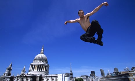 A base jumper leaps near St Paul’s Cathedral in London.