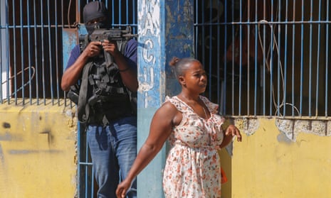 A police officer guarding the empty National Penitentiary in central Port-au-Prince on 14 March. Weeks earlier hundreds of inmates escaped.
