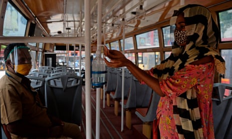 A women uses a sanitiser as she boards a bus in Chennai.