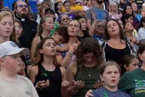 People attend a prayer service for flood victims
