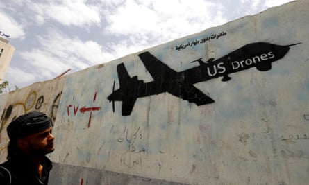 A Yemeni man looks at graffiti showing a US drone after al-Qaida in Yemen confirmed the death of its leader in US drone strike, in Sana’a, Yemen, 16 June 2015.