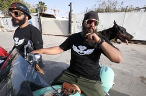 Benghazi, Libya: members of a Libyan motorcycle club and their dog arrive to a gathering near the historic tomb of anti-colonial leader and national hero Omar al-Mukhtar