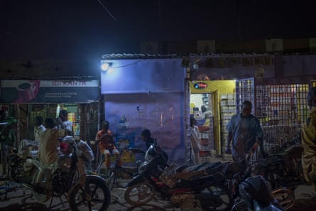 A busy street scene in the old town of Agadez by night