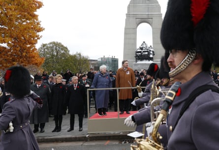 Richard Wagner, chief justice of the Supreme Court of Canada, from center left, Nancy Payne , National Silver Cross Mother, Mark Carney, Canada’s prime minister, and his wife Diana Fox Carney as the parade passes during a National Remembrance Day ceremony at the National War Memorial in Ottawa, Ontario, Canada, on Tuesday, Nov. 11, 2025.