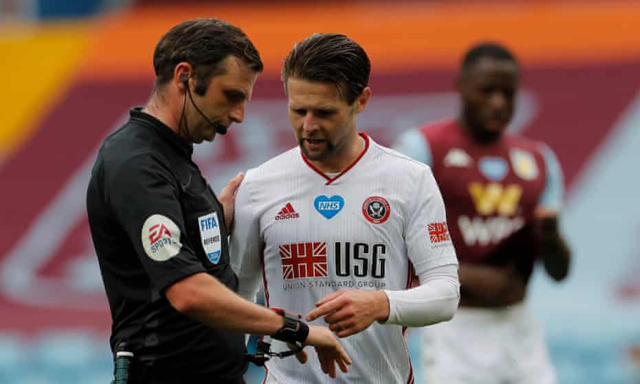Sheffield United’s Oliver Norwood confronts Michael Oliver at Villa Park but the referee received no goal alert from either his watch or earpiece, which are supposed to inform him if the ball has crossed the line.