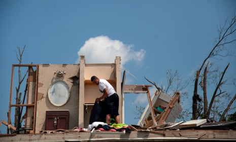A man in his tornado-damaged home in Trotwood, Ohio, last month.